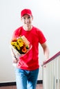 Delivery man with beautiful flower bouquet gift