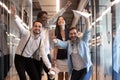Portrait happy diverse employees celebrating business victory in hallway Royalty Free Stock Photo