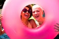 Portrait of happy diverse female friends having pool party, holding swim ring and smiling in garden Royalty Free Stock Photo