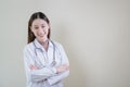 portrait happy doctor female wearing uniform with stethoscope arms crossed looking at camera. woman nurse standing at hospital. Royalty Free Stock Photo
