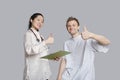 Portrait of happy doctor and patient gesturing thumbs up Royalty Free Stock Photo