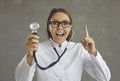 Portrait of happy doctor with stethoscope pointing one finger up struck by a great idea Royalty Free Stock Photo