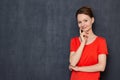 Portrait of happy dreamy young woman touching cheek with hand Royalty Free Stock Photo