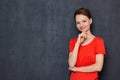 Portrait of happy dreamy young woman touching chin with hand Royalty Free Stock Photo