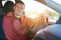 Portrait of a happy driver in a car in the rays of the setting sun Royalty Free Stock Photo