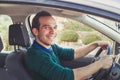 Portrait of happy driver in car. Smiling young man looking at camera. Royalty Free Stock Photo