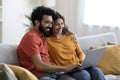 Portrait Of Happy Eastern Couple Browsing Internet On Laptop At Home Royalty Free Stock Photo