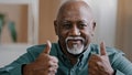 Portrait of happy elderly african american man smiling old senior putting two thumbs up positive grandfather looking at