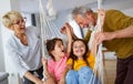 Portrait of happy elderly couple and grandchildren playing together Royalty Free Stock Photo