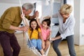 Portrait of happy elderly couple and grandchildren playing together Royalty Free Stock Photo