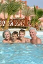 Portrait of happy elderly couple with grandsons