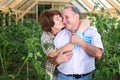 Portrait of happy elderly couple in the greenhouse Royalty Free Stock Photo