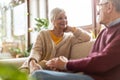 Happy elderly couple relaxing together on the sofa at home Royalty Free Stock Photo