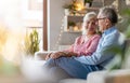 Happy elderly couple relaxing together on the sofa at home Royalty Free Stock Photo