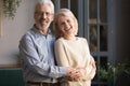 Portrait of happy elderly spouses posing for picture at home Royalty Free Stock Photo