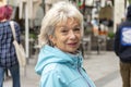 Portrait of happy elderly woman 60-70 years old on blurred background of street, crowd of people, Royalty Free Stock Photo