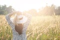 Portrait of happy and enjoying young woman on a meadow on a sunny summer day. Cheerful girl on sunset. Lifestyle and happiness co