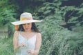 Portrait of happy and enjoying young woman on a meadow on a sunny summer day