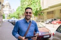 Portrait of happy entrepreneur with digital tablet standing on sidewalk in the city Royalty Free Stock Photo