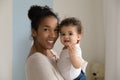 Portrait of happy ethnic mom and toddler baby Royalty Free Stock Photo