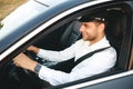 Portrait of happy european man taxi driver wearing uniform and c Royalty Free Stock Photo