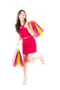 Portrait of a happy excited asian woman in red dress standing and holding colorful shopping bags with happy isolated Royalty Free Stock Photo