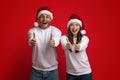 Portrait Of Happy Couple Wearing Santa Hats Showing Thumbs Up At Camera Royalty Free Stock Photo