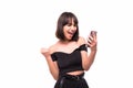 Portrait of a happy excited girl holding mobile phone and celebrating win isolated over grey background Royalty Free Stock Photo