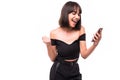 Portrait of a happy excited girl holding mobile phone and celebrating win isolated over grey background Royalty Free Stock Photo