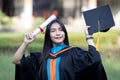 Portrait of happy and excited of young Asian female university graduate wears graduation gown and hat celebrates with degree in Royalty Free Stock Photo