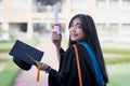 A happy and excited young Asian female university graduate Royalty Free Stock Photo