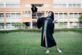 A happy and excited young Asian female university graduate Royalty Free Stock Photo