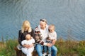 Portrait of a happy family against the background lake Royalty Free Stock Photo