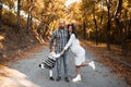 Portrait of happy family on background of golden park in autumn day. Father, daughter and pregnant mother. Royalty Free Stock Photo