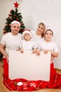 Portrait of happy family with big big white empty banner for text Royalty Free Stock Photo