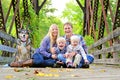 Portrait of Happy Family and Dog Outside in Fall Royalty Free Stock Photo