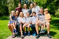 Portrait of happy family of eleven on bench Royalty Free Stock Photo