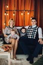 Portrait of happy family embracing in decorated studio.