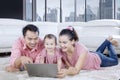 Happy family enjoying leisure time with a laptop Royalty Free Stock Photo