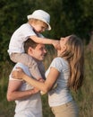 Portrait of happy family enjoying walk together at meadow in summer Royalty Free Stock Photo