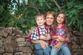 Portrait of happy family of farmers. Grandmother woman, grandson and little chicken, granddaughter outdoor in the farm