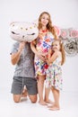 Portrait of a happy family father, pregnant mother, little daughter having fun together isolated over white with floral background Royalty Free Stock Photo