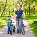 Portrait of a happy family - father and son bicycling in the park Royalty Free Stock Photo