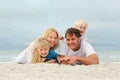 Portrait Of Happy Family of Four People Relaxing on the Beach