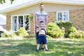 Portrait of happy family in front house