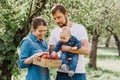 Portrait of Happy family hugging and spending time together outside in green nature Royalty Free Stock Photo