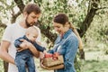 Portrait of Happy family hugging and spending time together outside in green nature Royalty Free Stock Photo