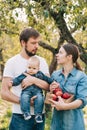 Portrait of Happy family hugging and spending time together outside in green nature Royalty Free Stock Photo