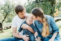 Portrait of Happy family hugging and spending time together outside in green nature Royalty Free Stock Photo