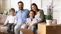 Portrait of happy family with kids relocating to new home Royalty Free Stock Photo